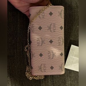 Selling a Crossbody MCM pink purse brand-new never been worn with the receipt